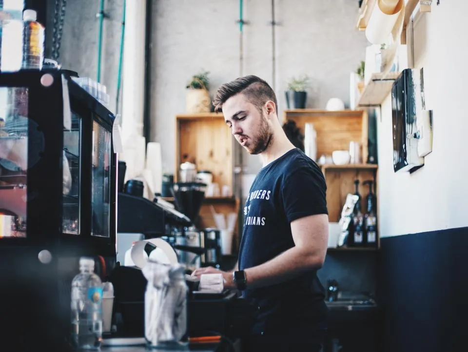 Coffee shop owner working behind the counter