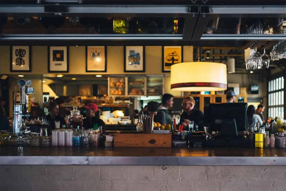 A restaurant bar with the register at the counter