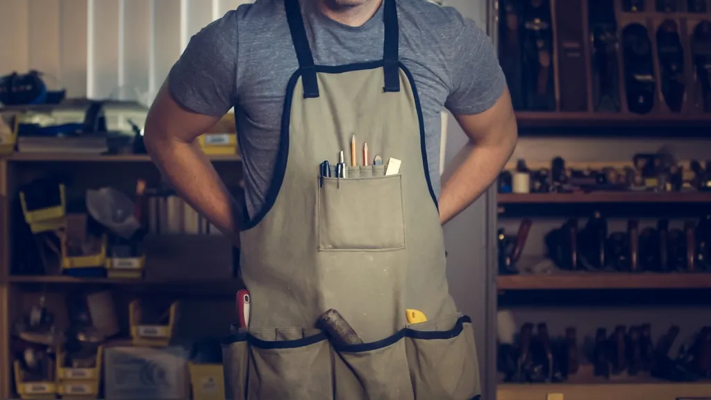 Craftsman in a work apron in his shop