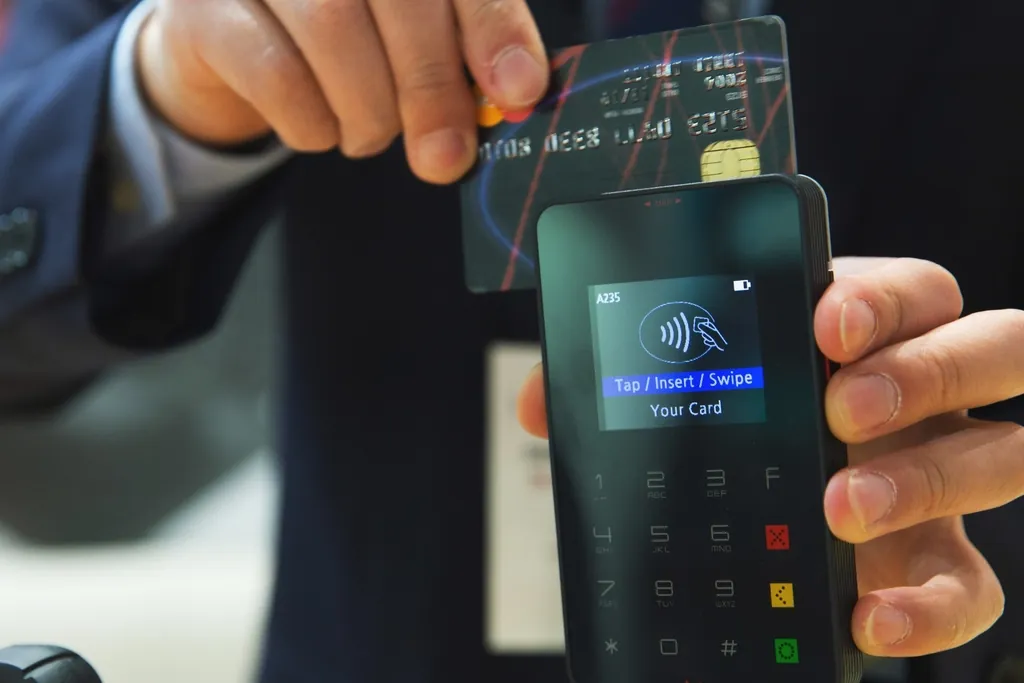 Customer tapping a card on a handheld terminal