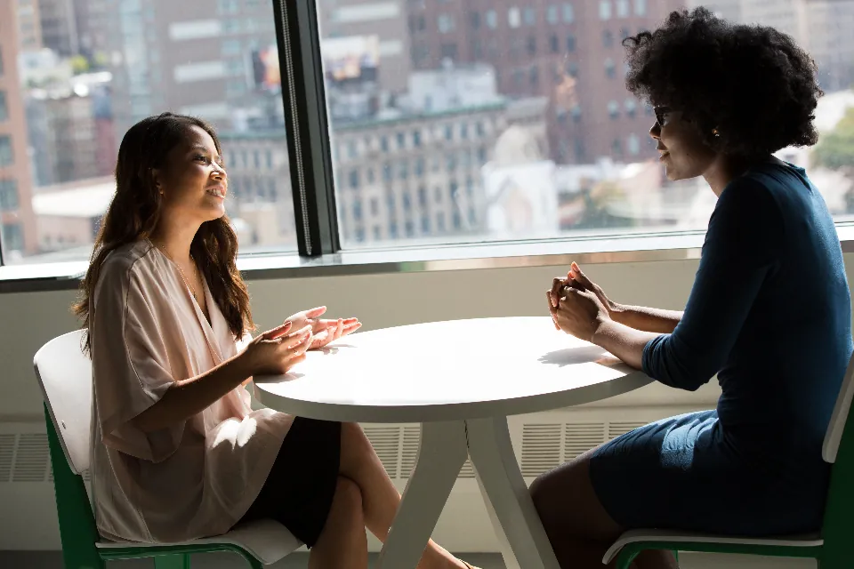 Two people talking business at a table