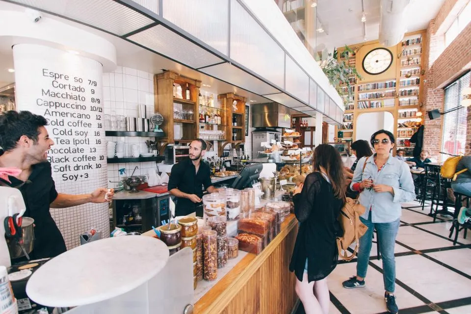 Busy cafe counter with customers ordering
