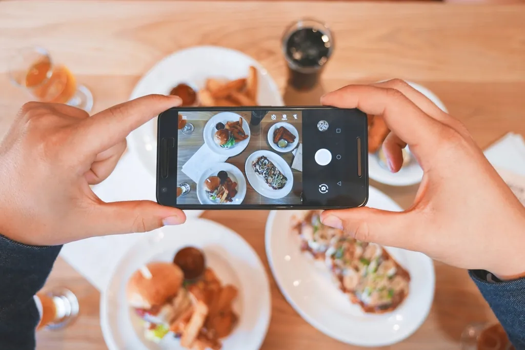 Phone photographing a table of brunch plates